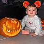 baby, child, pumpkin, jack_o_lantern, halloween, headband, orange, candle, floor, tile, living_room, sofa, candy_jar, curious, cute, costume, holiday, indoors, person, festive
