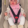 Aysha is registered to the contest to win money with this photo: baby, car_seat, bottle, pink_clothing, bonnet, white_tights, knit_booties, straps, child, infant, cute, indoors, seatbelt, portrait, person, sitting, smiling, face, headwear, baby_accessory