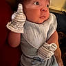 Jayce is registered to the contest to win money with this photo: baby, infant, child, portrait, wide_eyed, sitting, mittens, striped_mittens, bib, gray_clothing, white_clothing, indoor, warm_lighting, close_up, looking_away, reclining, cuddly, adorable, face, photography