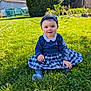 baby, blue_dress, child, cute, daylight, garden, girl, grass, greenery, happy, headband, nature, outdoor, person, plaid_skirt, playful, sitting, smiling, sunny, young