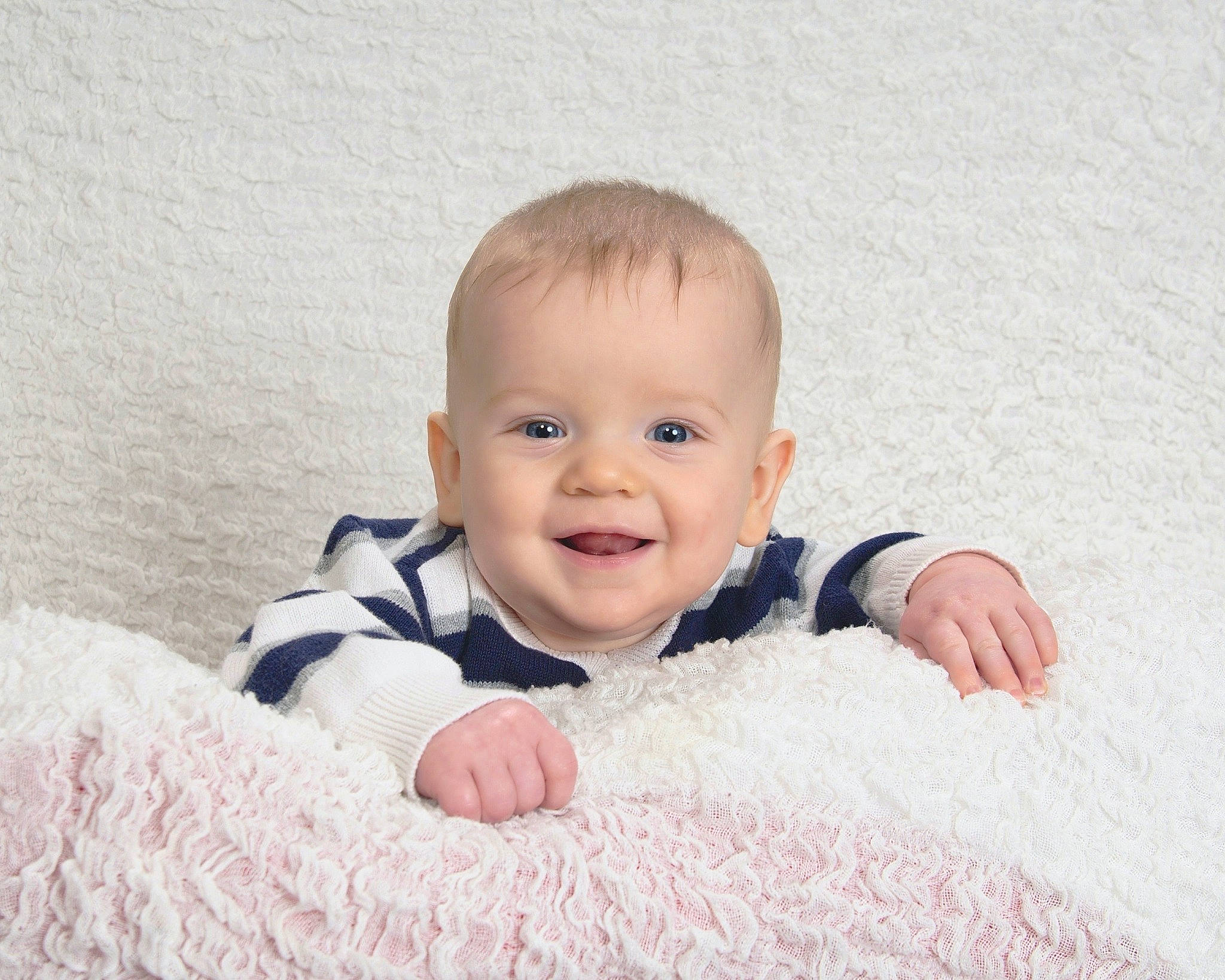 James joined the competition — help win amazing prizes! baby, baby_toddler_clothing, cheek, child, comfort, face, facial_expression, flash_photography, flooring, fun, happy, head, joy, laugh, linens, person, portrait_photography, sitting, skin, sleeve