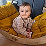 Eden participe au concours pour gagner de l'argent avec cette photo : baby, child, clothing, cozy, cushion, cute, face, floor, furniture, hands, happy, indoor, infant, person, portrait, sitting, smile, toy, wooden_rocker, yellow