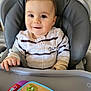 baby, child, cozy, cute, face, furniture, hand, happy, high_chair, indoor, infant, kitchen, person, playful, portrait, seatbelt, smiling, striped_clothing, table, toy