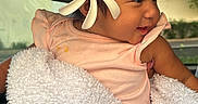 Remedyrose Garcia joined the competition — help win amazing prizes! baby, child, flower, blanket, pink_clothing, smile, face, portrait, indoor, car_interior, cute, happy, young_child, head, skin, person, seat, window, natural_light, cozy