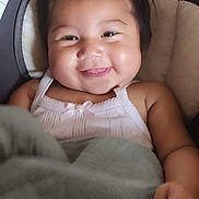 Remedyrose Garcia joined the competition — help win amazing prizes! baby, smiling, blanket, car_seat, child, cute, infant, portrait, happy, face, hair, clothing, sitting, indoors, person, screen_capture, social_media, mobile_phone, digital_photo, app_interface