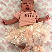 Treasure is registered to the contest to win money with this photo: baby, infant, pink, tutu, headband, blanket, heart_pattern, clothing, cute, sleepy, lying_down, soft_texture, newborn, adorable, tulle, socks, portrait, child, happy, small