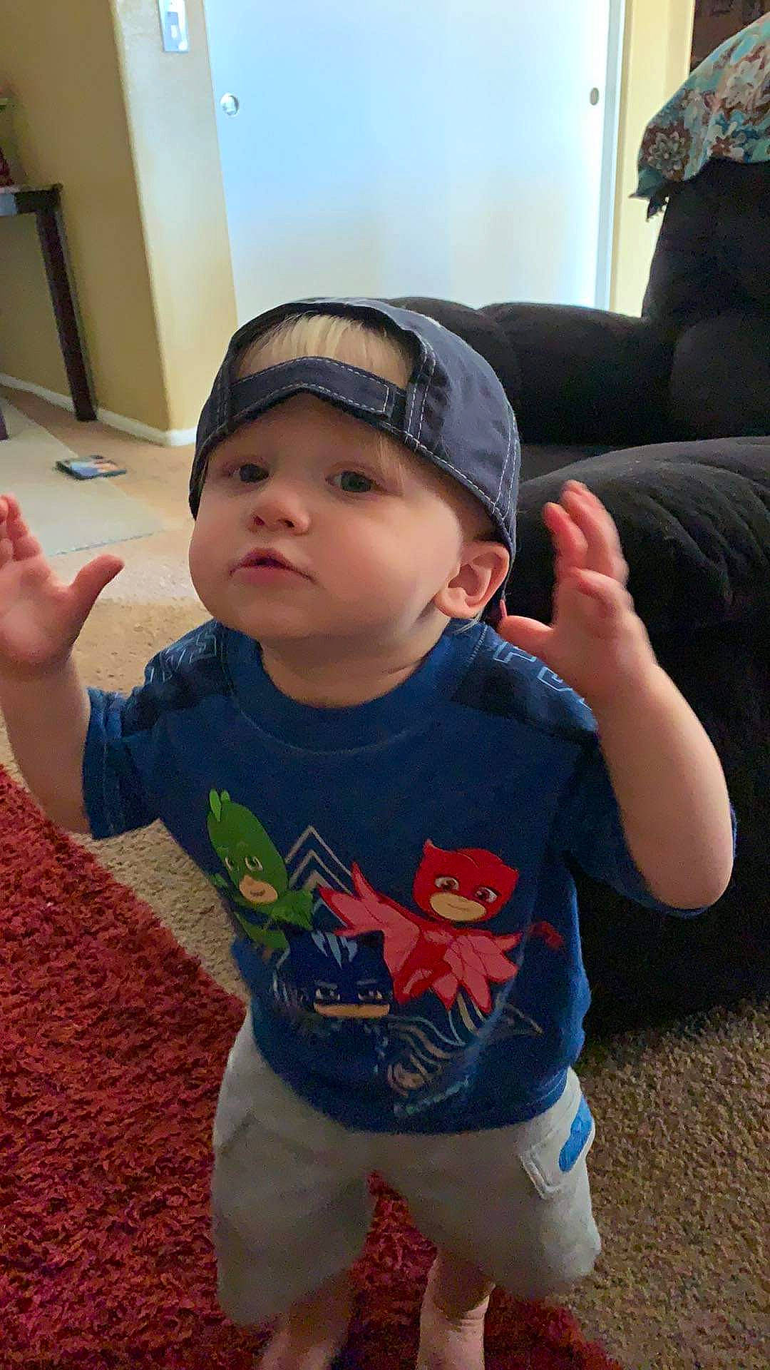 Jayce is registered to the contest to win money with this photo: arm, baby, baby_toddler_clothing, black, chin, cool, fun, happy, head, headwear, human_body, mouth, neck, nose, organ, person, plant, skin, sleeve, standing