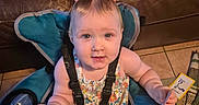 Kimi joined the competition — help win amazing prizes! toddler, child, baby, seat, blue_chair, flashcards, pink_bow, indoor, leather_couch, floor_tiles, curious_expression, clothing, person, smiling, hand, toy, home, casual, play, learning