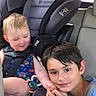 child, car_seat, car_interior, seatbelt, toddler, boy, smile, sibling, sitting, window, clothing, short_hair, car, family, seat, safety, cute, happy, travel, bonding