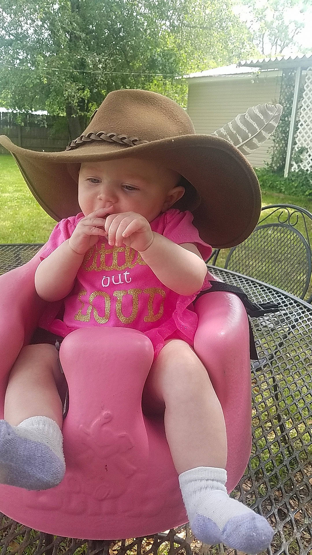 Rosaleigh is registered to the contest to win money with this photo: child, fashion_accessory, grass, hat, headgear, headwear, leg, lip, person, pink, sitting, summer, sun_hat, thigh, toddler, vacation