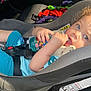 toddler, car_seat, child, curly_hair, blue_eyes, drink_bottle, plush_toy, seat_belt, sunlight, shadow, casual_clothing, sneakers, car_interior, relaxing, cute, young_child, sitting, safety_harness, toy, comfort