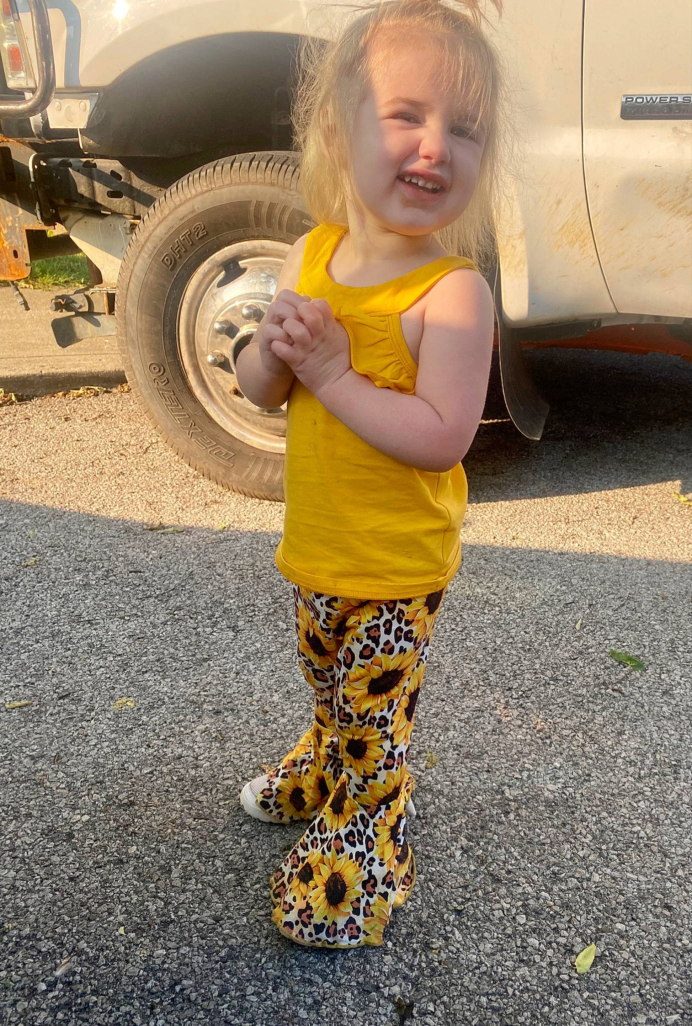 Bella joined the competition — help win amazing prizes! asphalt, automotive_exterior, automotive_tire, automotive_wheel_system, face, glasses, happy, leg, mammal, motor_vehicle, people, person, road_surface, sleeve, smile, tire, toddler, vehicle, vehicle_door, wheel