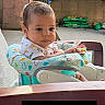 baby, child, infant, highchair, seat, outdoor, garden, plants, toy, curious, cute, person, face, portrait, colorful, clothing, table, sun_emoji, name_overlay, casual