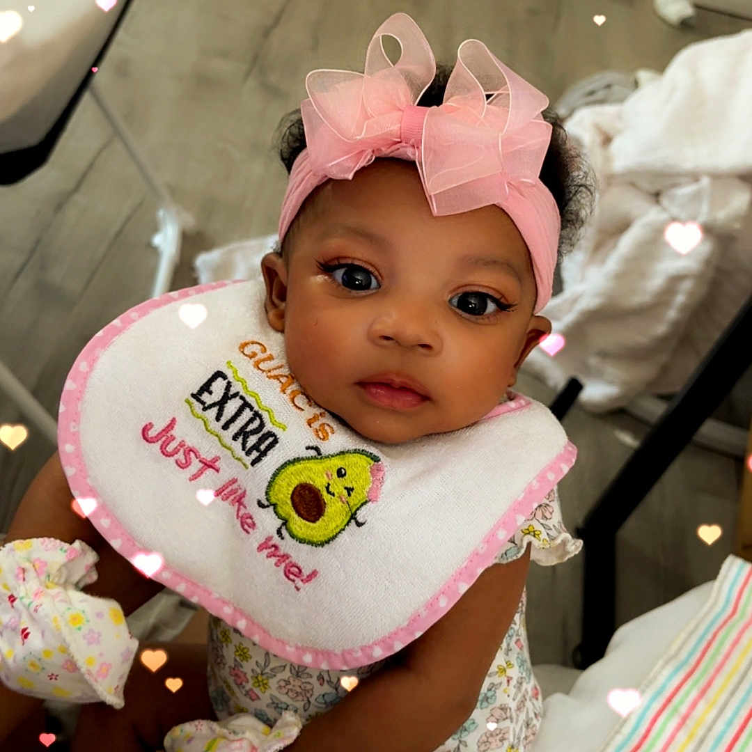 Ahmillya is registered to the contest to win money with this photo: baby, infant, girl, headband, bow, bib, sitting, mittens, clothing, bottle, floor, blanket, hearts, overlay, indoor, cute, child, person, portrait, love