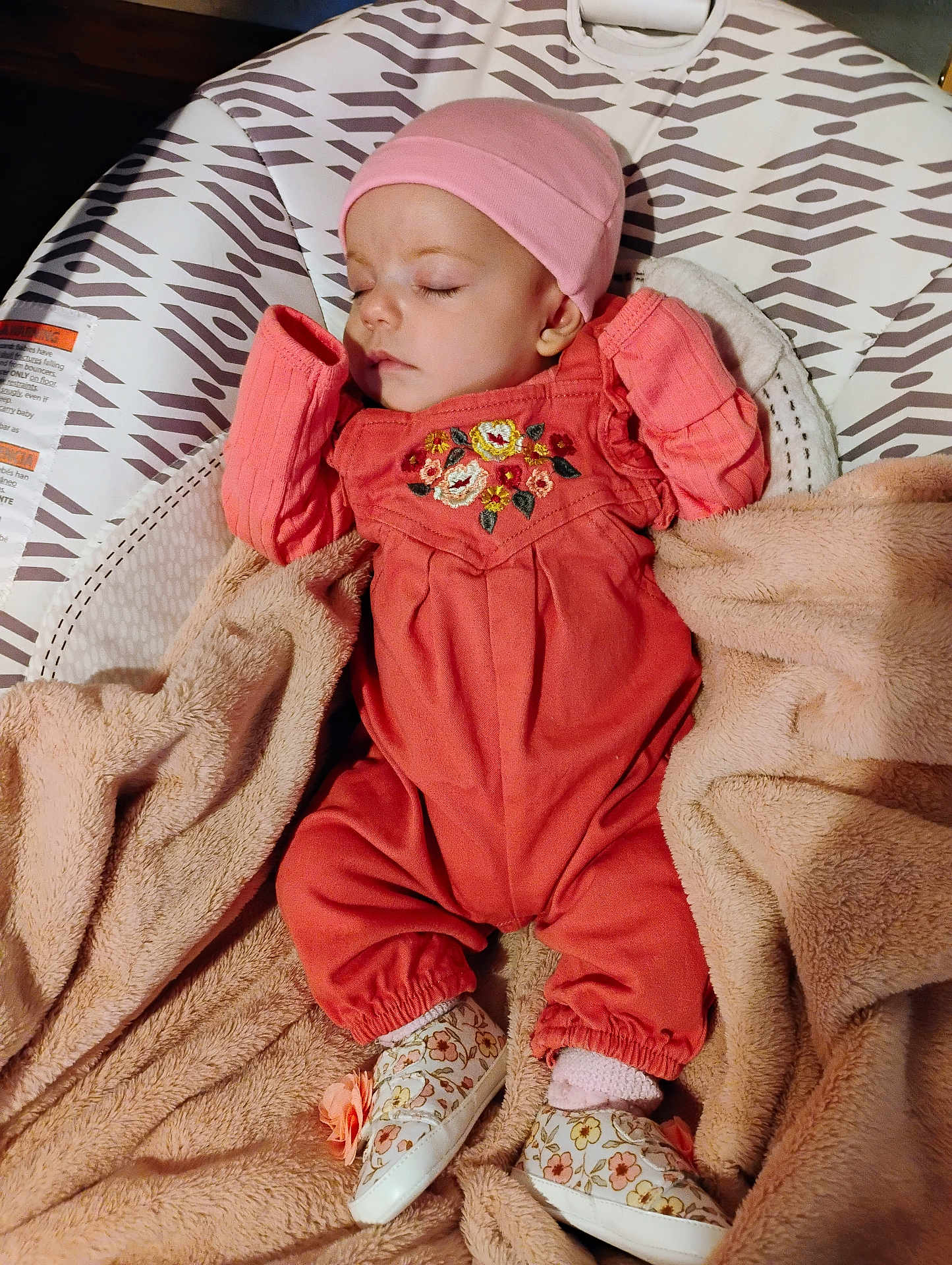 Hazel is registered to the contest to win money with this photo: baby, sleeping, infant, blanket, hat, footwear, patterned, baby_seat, soft_texture, pink, coral, cozy, cute, clothing, child, indoors, peaceful, portrait, resting, comfort