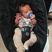 Keyden joined the competition — help win amazing prizes! baby, infant, pacifier, baby_rocker, black, striped_pants, beige_top, baby_clothing, indoor, child, cute, person, seatbelt, baby_seat, newborn, small_hands, small_feet, resting, holding, comfort