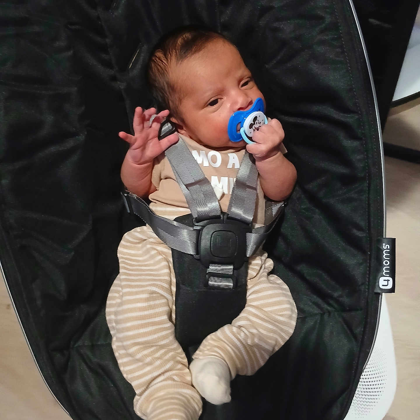 Keyden joined the competition — help win amazing prizes! baby, baby_clothing, baby_rocker, baby_seat, beige_top, black, child, comfort, cute, holding, indoor, infant, newborn, pacifier, person, resting, seatbelt, small_feet, small_hands, striped_pants