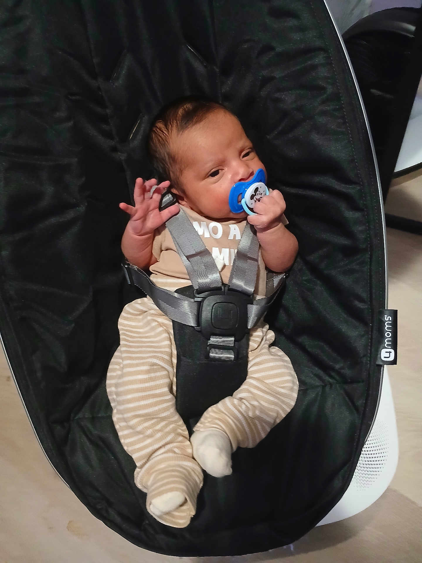 Keyden joined the competition — help win amazing prizes! baby, infant, pacifier, baby_rocker, black, striped_pants, beige_top, baby_clothing, indoor, child, cute, person, seatbelt, baby_seat, newborn, small_hands, small_feet, resting, holding, comfort