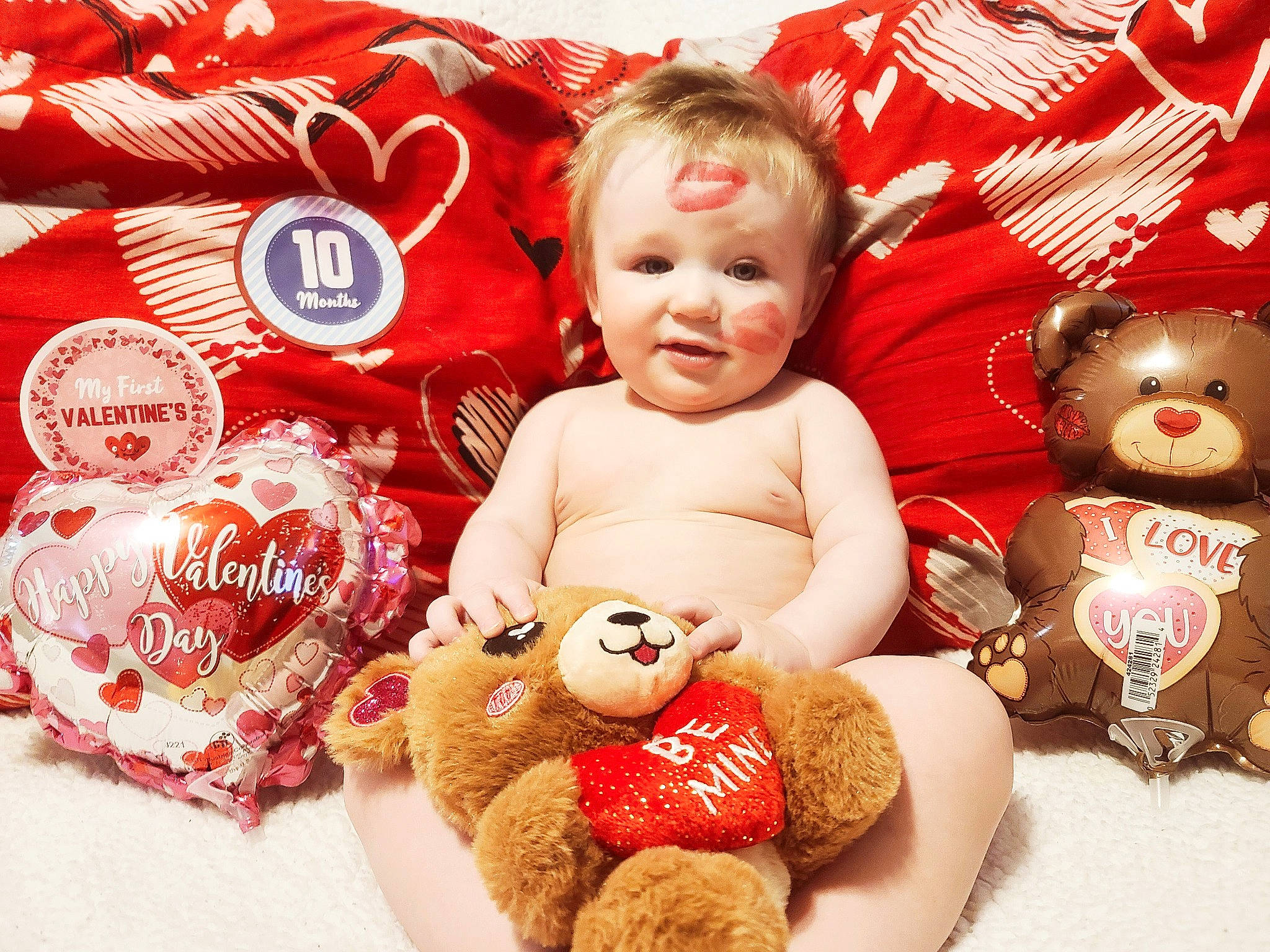 Drake is registered to the contest to win money with this photo: baby, baby_sleeping, baby_toddler_clothing, child, christmas_eve, event, fictional_character, happy, holiday, linens, person, plush, product, red, smile, stuffed_toy, sweetness, teddy_bear, textile, toddler