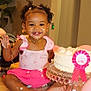 child, toddler, birthday_cake, cake, pink_clothing, smiling, happy, curly_hair, face_paint, messy, celebration, party, ribbon, jewelry, necklace, earrings, table, indoor, plant, foot