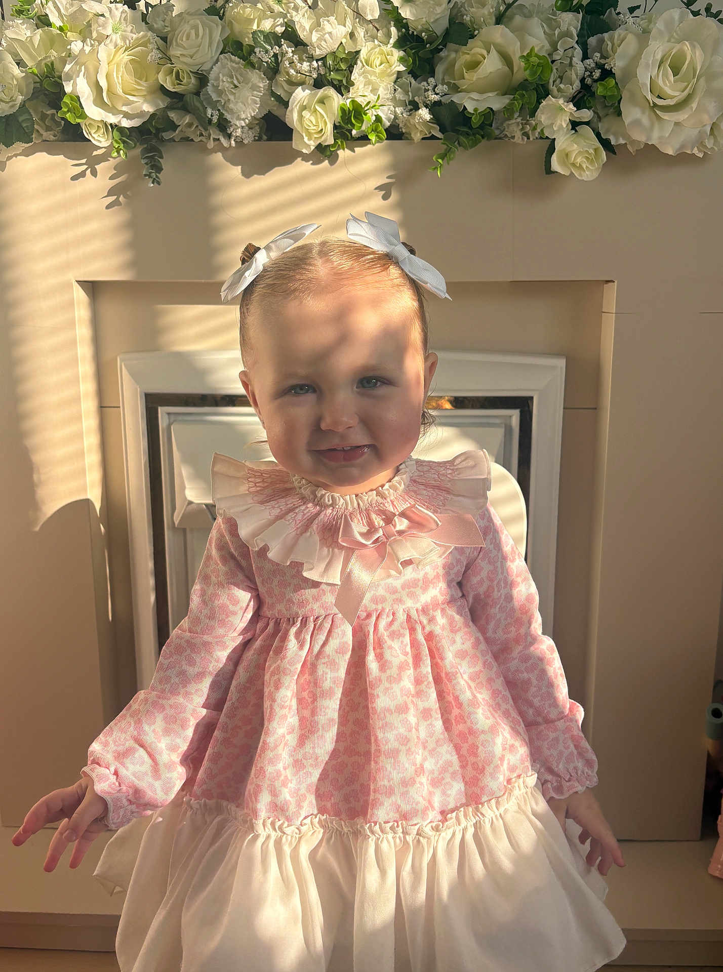 Flossie joined the competition — help win amazing prizes! child, toddler, girl, dress, pink, white, flowers, fireplace, indoor, portrait, smiling, ribbons, bows, long_sleeves, decor, shadow, sunlight, cute, happy, person