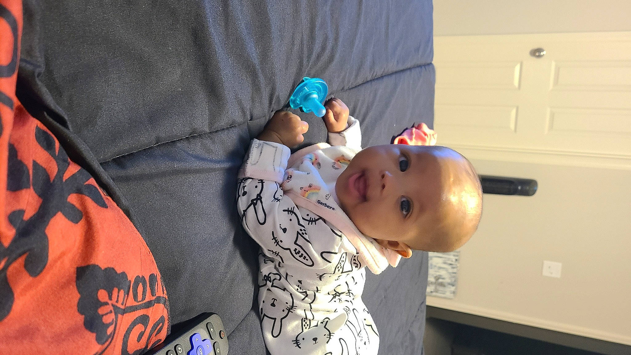 Nia is registered to the contest to win money with this photo: baby, baby_products, baby_toddler_clothing, cabinetry, child, comfort, couch, elbow, finger, fun, happy, hat, light_switch, person, room, sitting, sleeve, smile, t_shirt, toddler