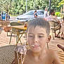 Petru Maria participe au concours pour gagner de l'argent avec cette photo : child, boy, ice_cream, cone, melting, summer, outdoor, patio, wet_hair, food, sweet, happy, casual, table, chair, people, car, daylight, nature, relaxed