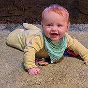 Killian is registered to the contest to win money with this photo: baby, smiling, yellow_outfit, bib, carpet, pacifier, toy, crawling, happy, child, indoor, cute, infant, playtime, person, face, hands, head, young, expression