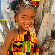 Legacy is registered to the contest to win money with this photo: accessories, bodypart, child, clothing, dress, earring, face, female, girl, hair, happy, head, jewelry, mouth, person, photography, portrait, shoulder, smile, tribe