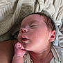 Ezekiel is registered to the contest to win money with this photo: newborn, baby, infant, sleeping, face, hand, skin, blanket, clothing, closeup, portrait, resting, peaceful, soft_light, indoors, human, cute, young, cozy, parent