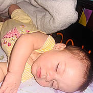 Jade joined the competition — help win amazing prizes! baby, sleeping, infant, bed, blanket, pillow, yellow_clothing, striped_clothing, floral_pattern, soft_texture, peaceful, face, hand, eyelashes, head, nap, indoors, cute, rest, child