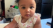 Zahmiyah Frison is registered to the contest to win money with this photo: baby, big_eyes, blanket, casual, child, curly_hair, cute, face, flamingo, furniture, indoor, infant, onesie, pink, portrait, room, sitting, soft, storage, television