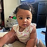 baby, child, curly_hair, onesie, pink, flamingo, indoor, blanket, soft, face, big_eyes, sitting, room, television, storage, furniture, casual, cute, infant, portrait