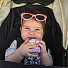 baby, child, stroller, sunglasses, pink, drink, sippy_cup, cute, happy, infant, person, face, hand, clothing, seat, black, white, toy, smile, young