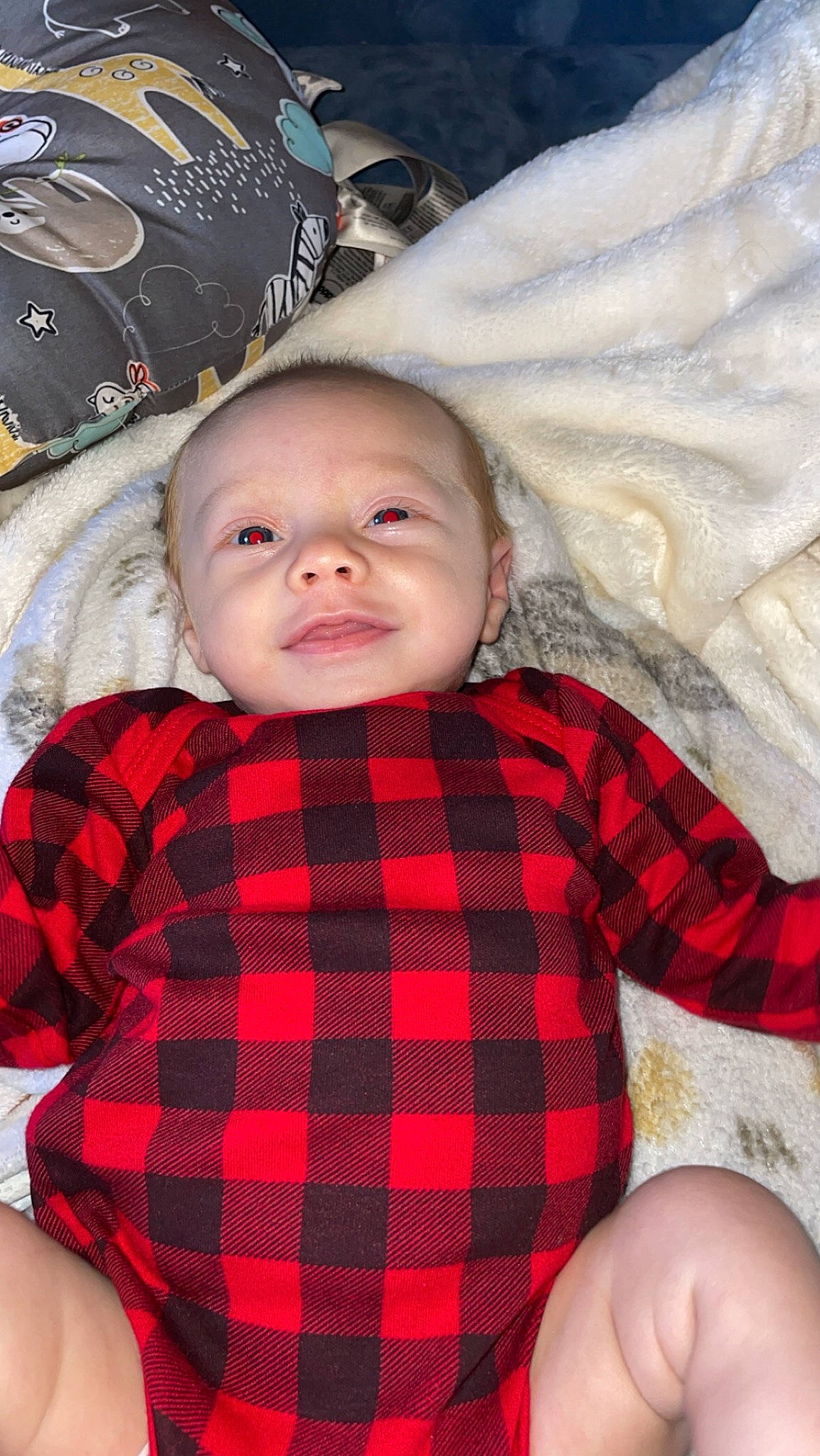 Hudson is registered to the contest to win money with this photo: baby, baby_toddler_clothing, cheek, child, chin, collar, eye, mammal, organ, outerwear, person, plaid, product, red, skin, sleeve, smile, tartan, textile, toddler