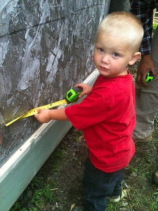 Michael Jr. is registered to the contest to win money with this photo: child, fun, garden, garden_tool, grass, leaf, leisure, people_in_nature, person, plant, play, recreation, soil, standing, t_shirt, toddler, tool, tree, trunk, wood