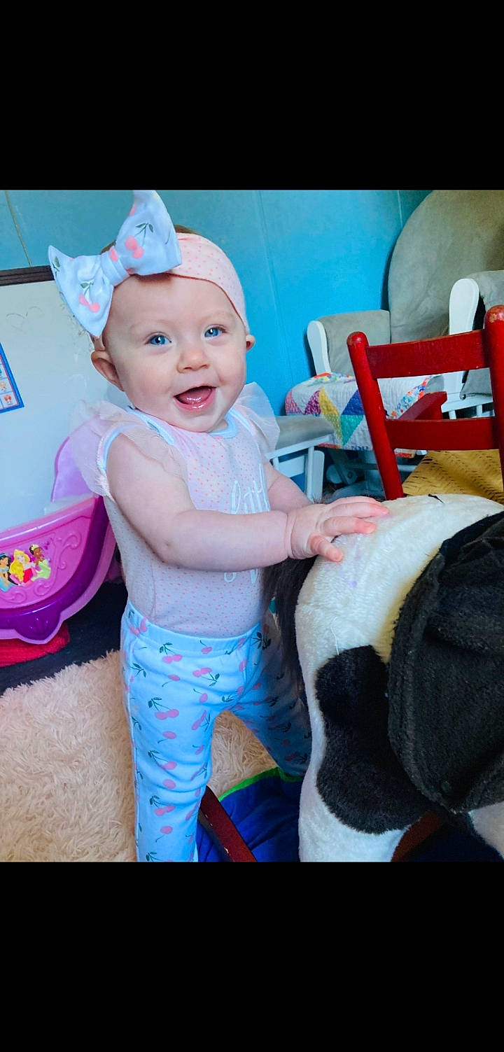 Brylee joined the competition — help win amazing prizes! baby, baby_products, baby_toddler_clothing, cap, chair, child, comfort, electric_blue, fashion_accessory, fun, happy, hat, headgear, headwear, magenta, person, pink, product, sitting, smile