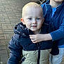 Carson is registered to the contest to win money with this photo: toddler, child, blue_eyes, jacket, pavement, outdoor, sibling, arm, hand, warm_clothing, zipper, person, cute, face, winter_wear, hooded_jacket, standing, smile, young_child, casual