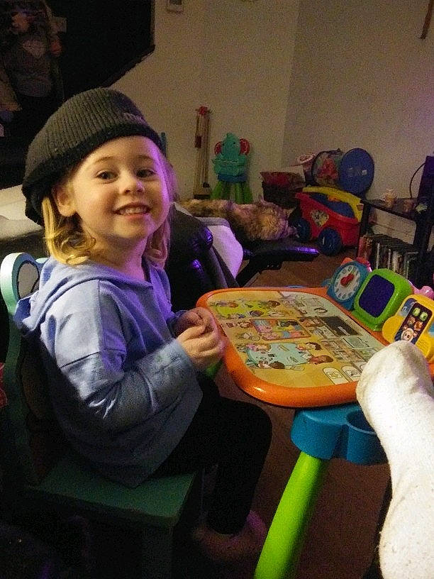 Jeanette is registered to the contest to win money with this photo: chair, child, fun, furniture, games, joy, person, play, recreation, sitting, smile, table, toddler