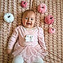 baby, blanket, celebration, child, costume, cute, face, happy, holiday_decor, indoor, infant, laying_down, patterned_background, pink_clothing, plush_pumpkins, portrait, smiling, soft_toys, tights, tutu