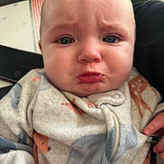Raelynn joined the competition — help win amazing prizes! baby, infant, face, pout, clothing, onesie, expression, indoor, person, skin, hand, zipper, cute, young_child, closeup, child, portrait, emotion, frown, soft_fabric