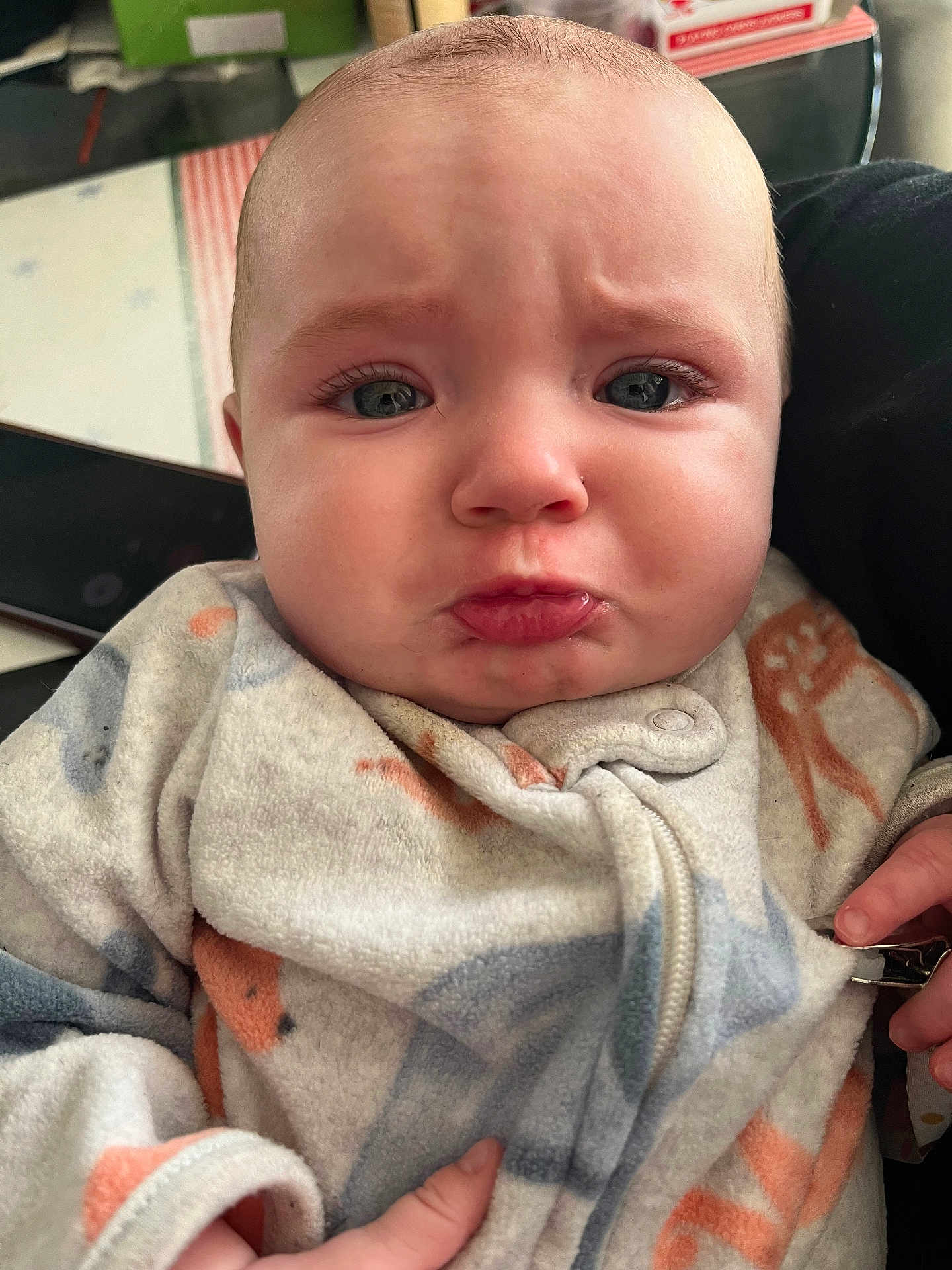 Raelynn joined the competition — help win amazing prizes! baby, infant, face, pout, clothing, onesie, expression, indoor, person, skin, hand, zipper, cute, young_child, closeup, child, portrait, emotion, frown, soft_fabric