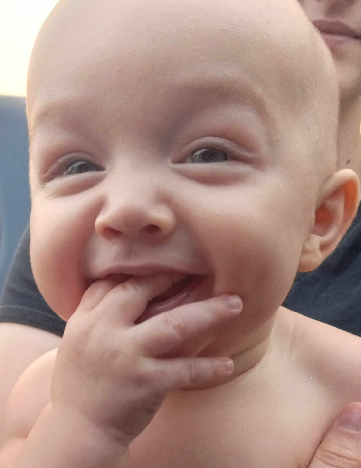 Azahni is registered to the contest to win money with this photo: baby, child, face, hand, fingers, smile, happy, skin, head, mouth, eyes, person, closeup, expression, infant, human, adult_hand, background, holding, portrait