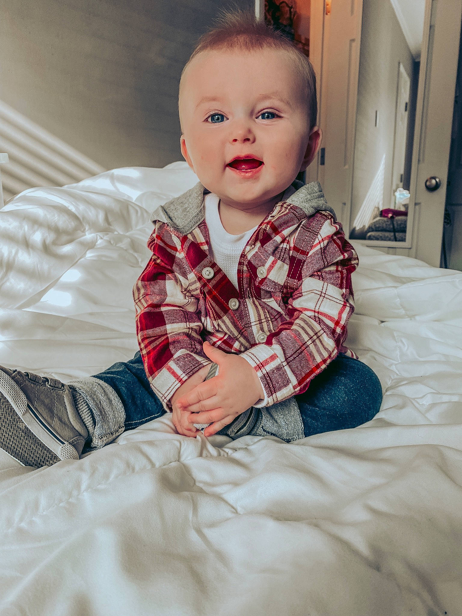 Tucker is registered to the contest to win money with this photo: baby, baby_toddler_clothing, cheek, child, collar, comfort, dress_shirt, flash_photography, flooring, fun, hairstyle, happy, human_body, linens, person, sitting, sleeve, smile, standing, t_shirt