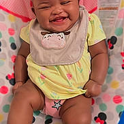 Promise joined the competition — help win amazing prizes! baby, smiling, laughing, yellow_dress, headband, bib, sitting, polka_dot, mickey_mouse, colorful, happy, infant, footwear, cute, child, indoor, pattern, playful, cheerful, young