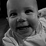 baby, smiling, close_up, black_and_white, face, child, infant, happy, cute, clothing, portrait, eyes, mouth, teeth, sweater, person, indoor, expression, young, head
