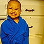 child, toddler, smiling, blue_bathrobe, indoor, dresser, furniture, happy, person, cute, portrait, young_child, clothing, cabinet, home, joyful, small_child, baby, face, standing