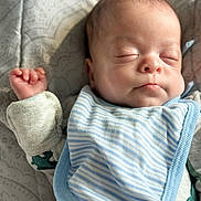 Lian joined the competition — help win amazing prizes! baby, sleeping, infant, bib, clothing, face, hand, peaceful, soft_light, portrait, closeup, skin, fabric, bed, rest, young_child, cute, indoor, cozy, newborn