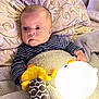 Lian joined the competition — help win amazing prizes! baby, blanket, toy, light, plush_toy, pillow, indoor, child, patterned_clothing, striped_shirt, cozy, cute, wide_eyes, infant, soft_toys, bedroom, warm_lighting, face, person, holding