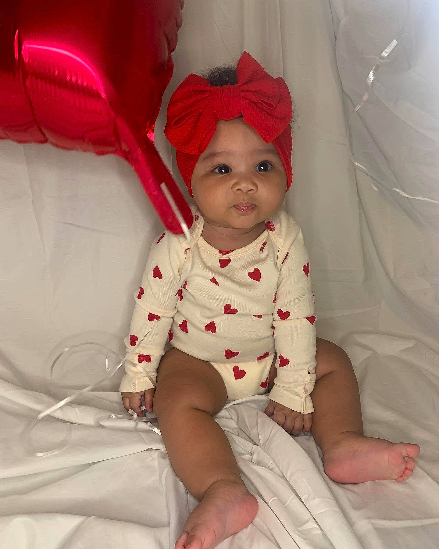 Kennadi joined the competition — help win amazing prizes! baby, baby_products, baby_toddler_clothing, carmine, child, comfort, fashion_accessory, foot, fun, headwear, human_leg, knee, lap, leg, linens, person, pink, sitting, skin, sleeve